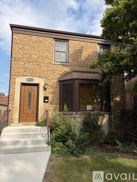 A brick house with a brown door and a window.