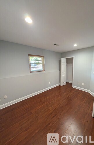 A room with wooden floors and a window.