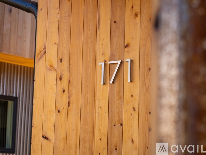 A wooden wall with the number 171 on it.