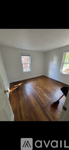A room with wooden flooring and a window.