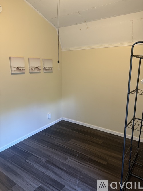 A room with a wooden floor and a ladder.