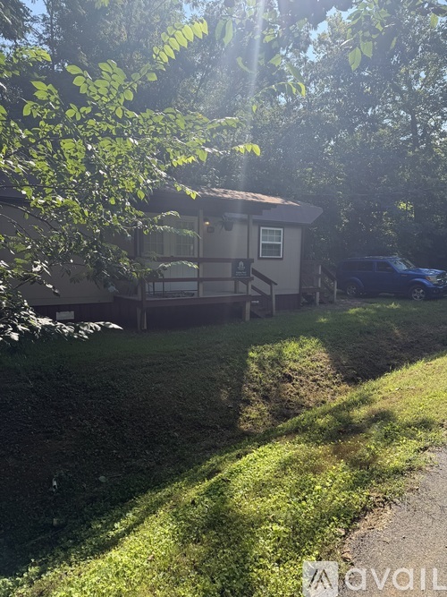 A house with a blue car parked in front.
