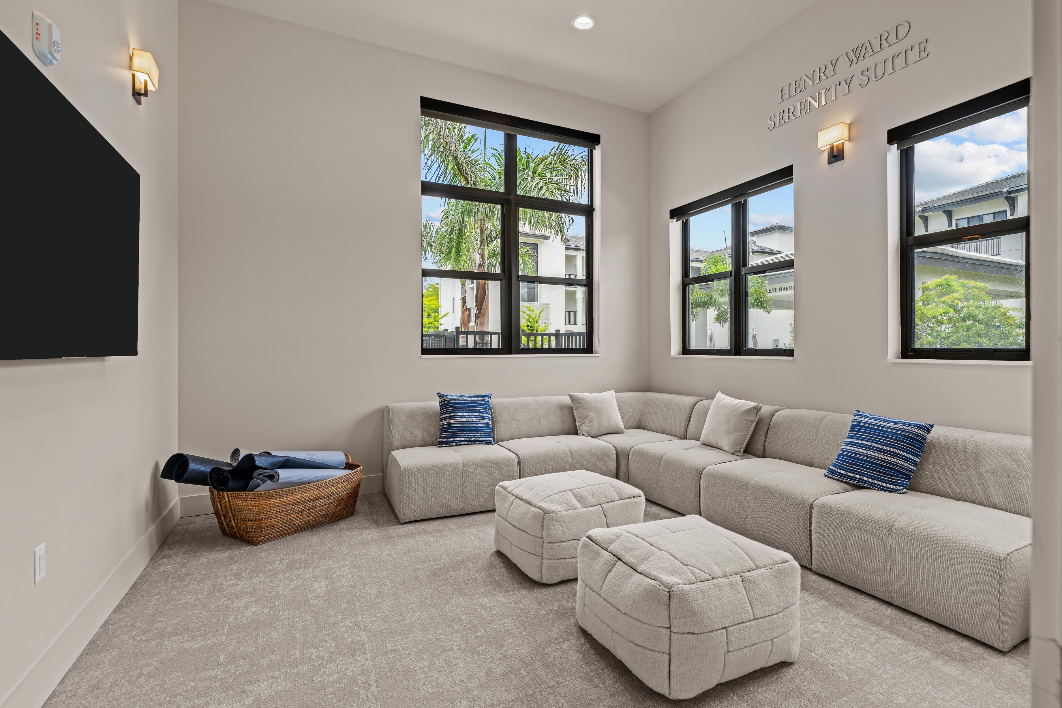 A spacious living room with a large sectional sofa and a wooden coffee table.