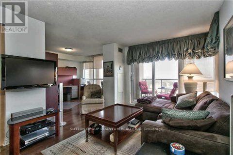 A living room with a brown couch and a wooden coffee table.