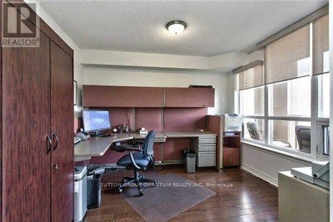 A room with a desk and a computer monitor.