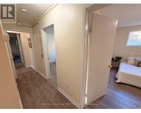 A bedroom with a bed, nightstand, and window.