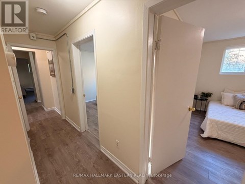 A bedroom with a bed, nightstand, and window.