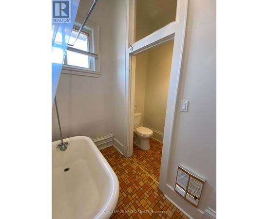 A bathroom with a white tub and toilet.