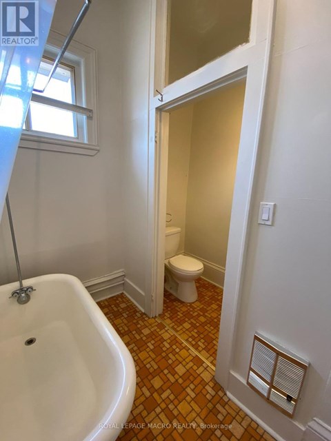A bathroom with a white tub and toilet.
