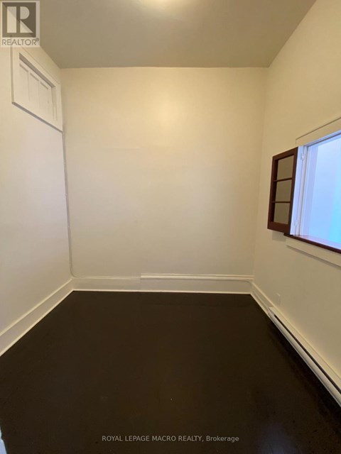 A white room with a window and a door.