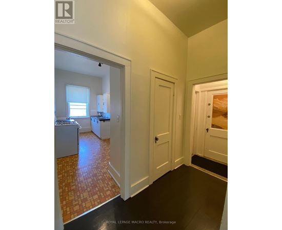 A kitchen with white cabinets and a tiled floor.