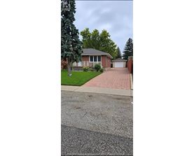 A house with a driveway in front of it.
