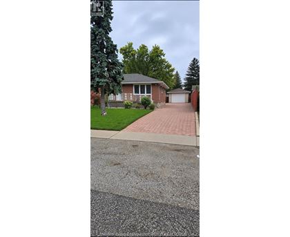 A house with a driveway in front of it.