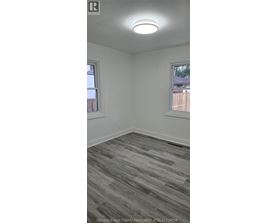 A room with a grey floor and a window.