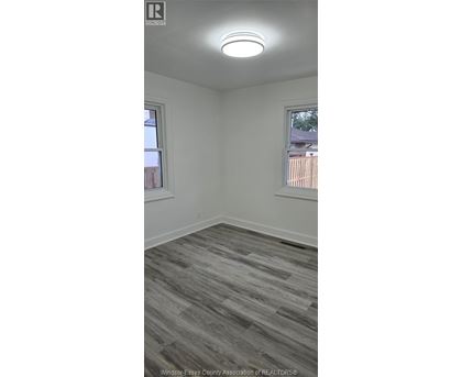 A room with a grey floor and a window.