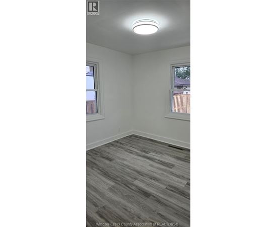 A room with a grey floor and a window.