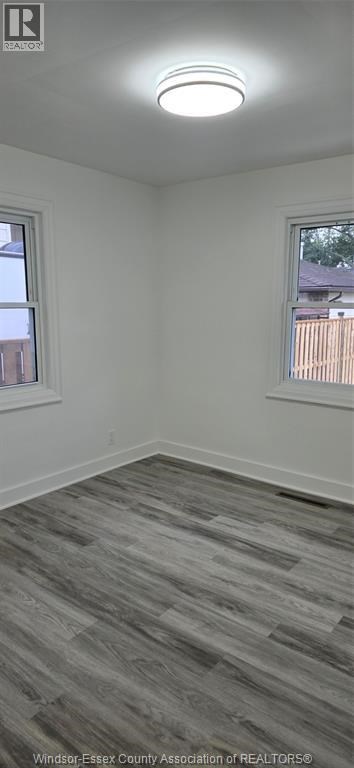 A room with a grey floor and a window.