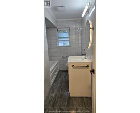 A bathroom with a sink, toilet, and tub.