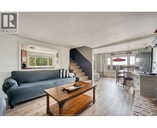A living room with a grey couch and a wooden coffee table.