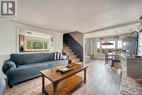 A living room with a grey couch and a wooden coffee table.