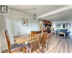 A dining room with a wooden table and chairs.