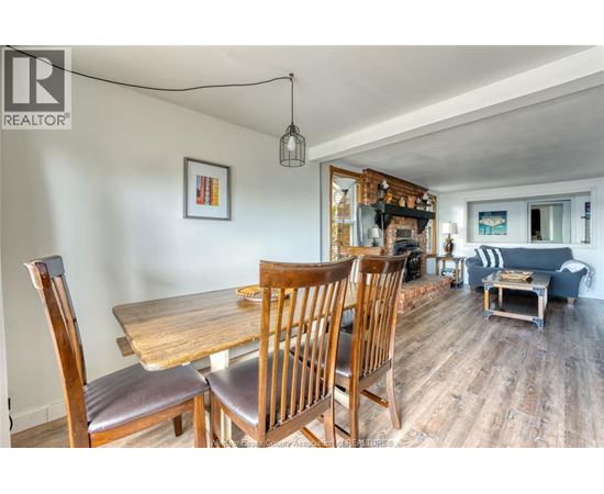 A dining room with a wooden table and chairs.