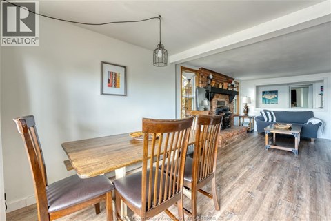 A dining room with a wooden table and chairs.