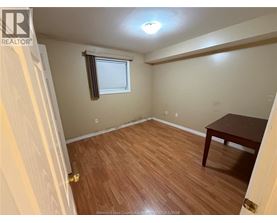 A room with a wooden floor and a table.