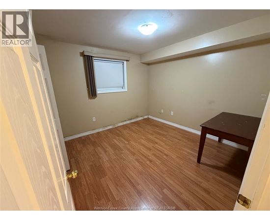 A room with a wooden floor and a table.