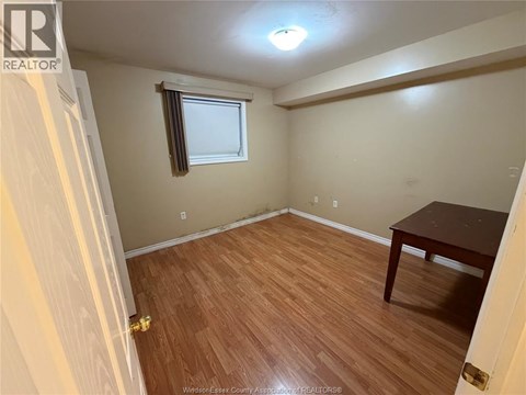 A room with a wooden floor and a table.