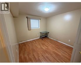 A room with wooden flooring and a small table.