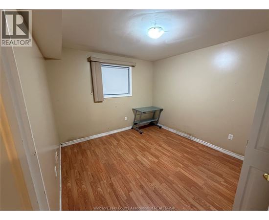 A room with wooden flooring and a small table.