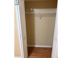 A white door is open to a room with a white shelf.