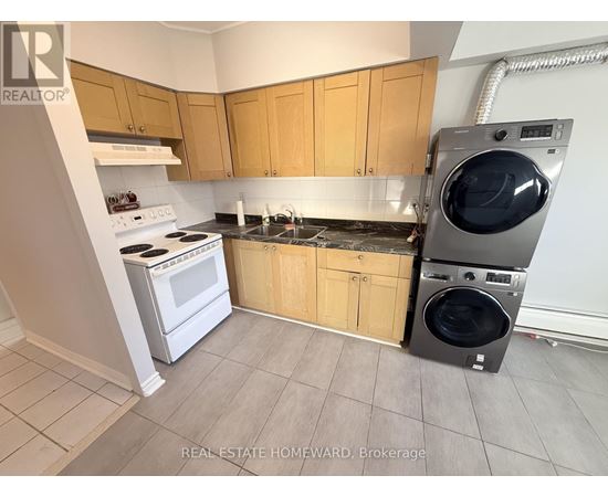 A laundry room with a washer and dryer stacked on top of each other.