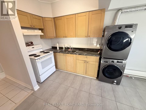 A laundry room with a washer and dryer stacked on top of each other.