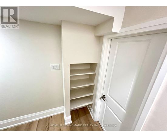 A white door with a black handle is closed.