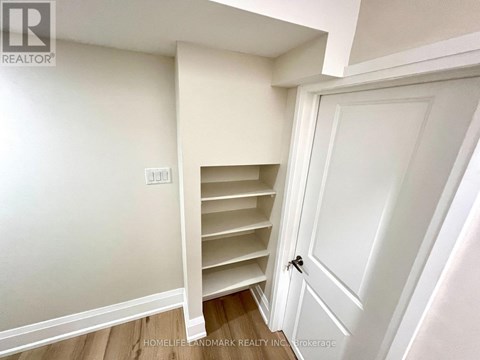 A white door with a black handle is closed.