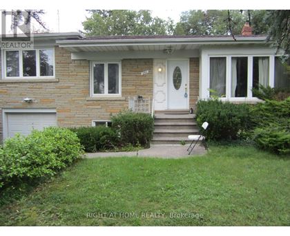 A house with a white door and a small front yard.