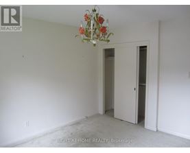 A room with a chandelier and two doors.