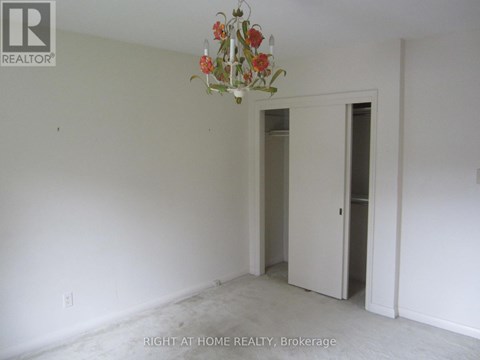 A room with a chandelier and two doors.