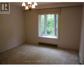 A room with a window and a chandelier.