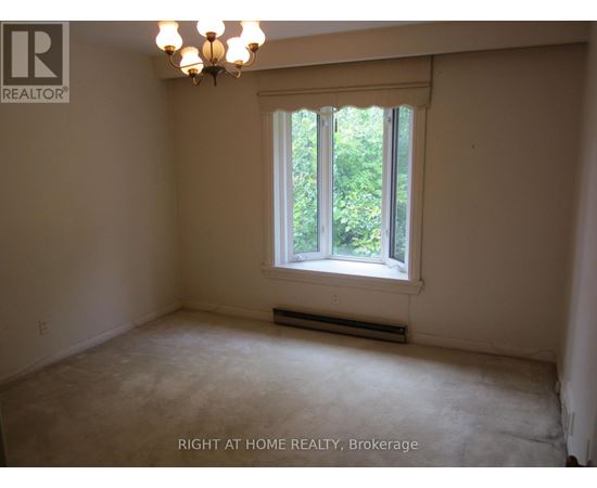 A room with a window and a chandelier.