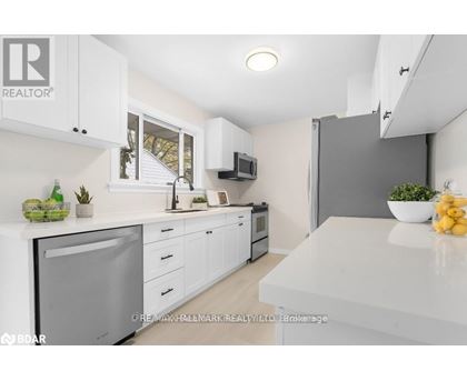 A modern kitchen with white cabinets and appliances.