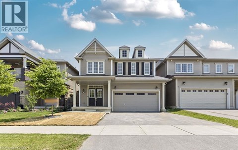 A large, two-story house with a garage is for sale.