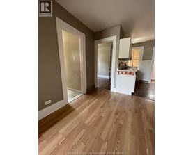 A kitchen area with a sink and cabinets.