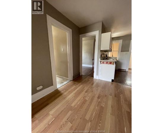 A kitchen area with a sink and cabinets.