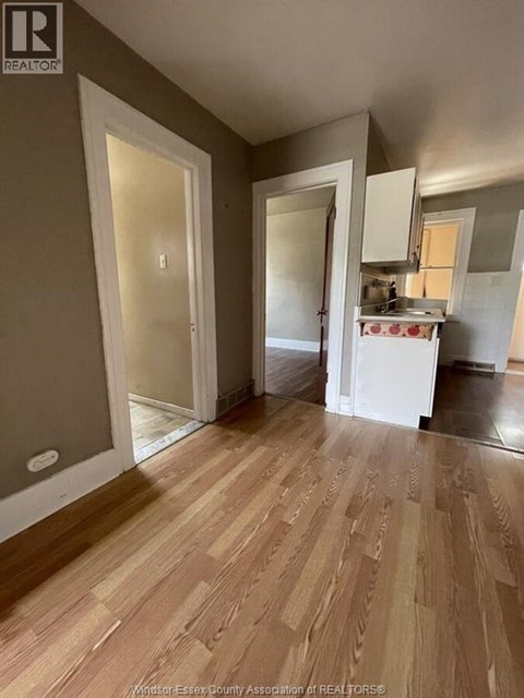A kitchen area with a sink and cabinets.