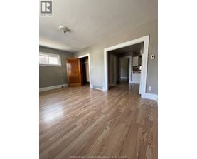 A room with wooden floors and a large open doorway.