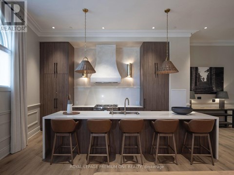 A modern kitchen with a central island and bar stools.