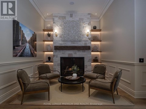 A living room with a fireplace and a painting on the wall.